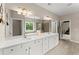 Bright bathroom featuring double vanity, quartz counters, tile floor, and well-lit mirror at 4130 Millbrook Ct, Suwanee, GA 30024