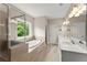 The bathroom offers a tiled shower and soaking tub along with double sinks at 4130 Millbrook Ct, Suwanee, GA 30024