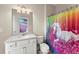 Colorful bathroom featuring a bright shower curtain, marble countertop, and plenty of lighting at 4130 Millbrook Ct, Suwanee, GA 30024