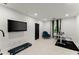 This exercise room includes a large wall-mounted television and plenty of workout space at 4130 Millbrook Ct, Suwanee, GA 30024