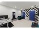 Bright exercise room featuring modern equipment and vibrant black and white striped accent wall at 4130 Millbrook Ct, Suwanee, GA 30024