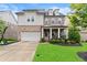 Charming two-story home features a mix of brick and siding, a welcoming front porch, and a well-manicured lawn at 4130 Millbrook Ct, Suwanee, GA 30024