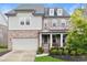 Charming two-story home features a mix of brick and siding, a welcoming front porch, and a well-manicured lawn at 4130 Millbrook Ct, Suwanee, GA 30024