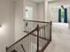 Hallway with dark iron railing with views of bedroom and bathroom at 4130 Millbrook Ct, Suwanee, GA 30024