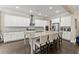 Bright, open kitchen with white cabinetry, granite countertops, stainless steel appliances, and hardwood flooring at 4130 Millbrook Ct, Suwanee, GA 30024