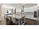 Spacious kitchen with white cabinets, stainless steel appliances, granite countertops, and a large central island at 4130 Millbrook Ct, Suwanee, GA 30024