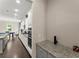 Well-lit kitchen with stainless steel appliances and granite countertops, leading into a dining area with ample seating at 4130 Millbrook Ct, Suwanee, GA 30024