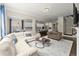 Open-concept living room seamlessly connecting to the kitchen, with modern finishes, hardwood flooring, and ample natural light at 4130 Millbrook Ct, Suwanee, GA 30024