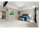 The main bedroom boasts a tray ceiling, a decorative light fixture, and an adjoining stairway at 4130 Millbrook Ct, Suwanee, GA 30024