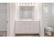 Bright bathroom with double sinks, white cabinetry, and modern fixtures and a toilet at 8505 Poston Place Lot 141, Douglasville, GA 30134