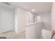 Upstairs hallway with a neutral color scheme and carpeted flooring at 8505 Poston Place Lot 141, Douglasville, GA 30134