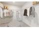 Spacious walk-in closet with organized hanging storage and a central ottoman at 8505 Poston Place Lot 141, Douglasville, GA 30134