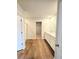 A bright primary bathroom with wood look floors, double sinks, glass enclosed shower and walk in closet at 2674 Mourning Dove Drive (Lot 37), Grayson, GA 30017