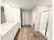 A bright primary bathroom with wood look floors, double sinks and a glass enclosed shower at 2674 Mourning Dove Drive (Lot 37), Grayson, GA 30017
