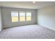 Large bonus room with plush carpeting, recessed lighting, and three large windows at 2674 Mourning Dove Drive (Lot 37), Grayson, GA 30017