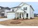 Charming two-story home featuring white siding, a covered entry, and a convenient two-car garage at 2674 Mourning Dove Drive (Lot 37), Grayson, GA 30017