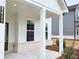 Close up view of the front porch showing white columns, brick trim and the house number at 2674 Mourning Dove Drive (Lot 37), Grayson, GA 30017