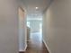 Hallway view with hardwood flooring and neutral paint leading to a sunlit living area at 2674 Mourning Dove Drive (Lot 37), Grayson, GA 30017