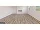 Spacious living room with wood-look flooring, modern fireplace, and abundant natural light at 8503 Polston Lot 142 Pl, Douglasville, GA 30134