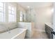 Gorgeous bathroom features a stand alone tub and a glass enclosed shower at 148 Palm St, Holly Springs, GA 30115