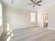 Large primary bedroom featuring a ceiling fan, carpet, and en suite bathroom at 148 Palm St, Holly Springs, GA 30115