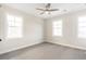Spacious bedroom with soft carpeting and a ceiling fan, offering a serene atmosphere at 148 Palm St, Holly Springs, GA 30115