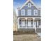 Charming two-story home with brick foundation, covered porch, and inviting curb appeal at 148 Palm St, Holly Springs, GA 30115