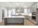Well-equipped kitchen featuring a center island, stainless appliances, and custom cabinetry at 148 Palm St, Holly Springs, GA 30115