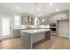 Modern kitchen with gray cabinets, stainless steel appliances, and a large island at 148 Palm St, Holly Springs, GA 30115