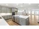 Beautiful kitchen with stainless steel appliances, quartz counters, island and open to living area at 148 Palm St, Holly Springs, GA 30115