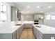 Modern kitchen with stainless steel appliances, quartz counters, stylish cabinets, and pendant lighting at 148 Palm St, Holly Springs, GA 30115