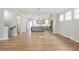 Spacious living area with hardwood floors, leading into a modern kitchen at 148 Palm St, Holly Springs, GA 30115
