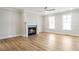 Bright living room with hardwood floors, fireplace, and large windows at 148 Palm St, Holly Springs, GA 30115
