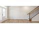 Open-concept living space with hardwood floors and staircase at 148 Palm St, Holly Springs, GA 30115