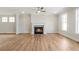 Inviting living room with hardwood floors, fireplace, and abundant natural light at 148 Palm St, Holly Springs, GA 30115