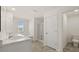 Bright, clean bathroom featuring double sinks, a shower, and a tiled floor, perfect for a modern home at 1628 Palladian Dr, Lithonia, GA 30058
