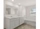 Modern bathroom with double sinks, bathtub, and tiled flooring, offering a luxurious feel at 1628 Palladian Dr, Lithonia, GA 30058