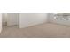 Bright bedroom with neutral carpet, white walls, and a sun-lit window overlooking houses at 1628 Palladian Dr, Lithonia, GA 30058