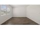 Clean bedroom features wood-look flooring, natural light from window, and neutral paint color at 1628 Palladian Dr, Lithonia, GA 30058