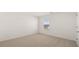 Well-lit bedroom with neutral carpet, white walls, and a window with blind coverings at 1628 Palladian Dr, Lithonia, GA 30058