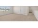 A spacious bedroom is filled with neutral carpet and plenty of natural light from the window at 1628 Palladian Dr, Lithonia, GA 30058