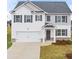 Charming two-story home with a two-car garage, gray shutters, and a well-manicured front yard at 1628 Palladian Dr, Lithonia, GA 30058