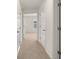 Neutral carpeted hallway with white doors leading to various rooms in the house at 1628 Palladian Dr, Lithonia, GA 30058
