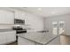 Modern kitchen features granite countertops, stainless appliances, and a convenient center island at 1628 Palladian Dr, Lithonia, GA 30058