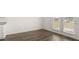 Bright living room features hardwood floors and sliding glass doors leading to the backyard at 1628 Palladian Dr, Lithonia, GA 30058