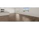 Open-concept living room features hardwood floors, lots of light, and flows to the kitchen at 1628 Palladian Dr, Lithonia, GA 30058