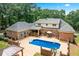 Aerial view of the private backyard with a pool and outdoor seating at 2065 Innsfail Dr, Snellville, GA 30078