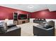 Basement recreation room with sleek furniture, a large TV, and shelving for entertainment at 2065 Innsfail Dr, Snellville, GA 30078