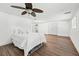 Basement bedroom showcasing modern ceiling fan, wood flooring, and natural light from the window at 2065 Innsfail Dr, Snellville, GA 30078