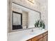 Bathroom vanity with a large mirror and decorative wallpaper, providing both functionality and aesthetic appeal at 2065 Innsfail Dr, Snellville, GA 30078